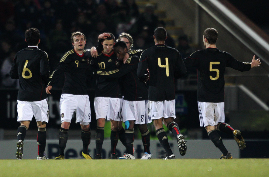 Denis Thomalla (third from left) is congratulated by his team-mates after scoring the winner against England in Chesterfield.
